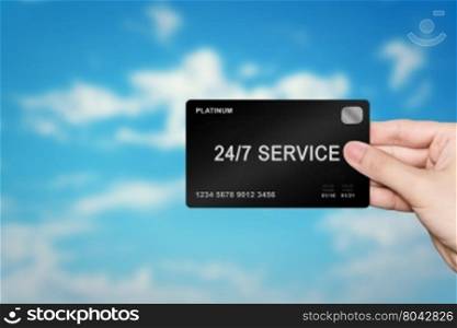 hand picking 24 hours a day, 7 days a week service platinum card on blur background