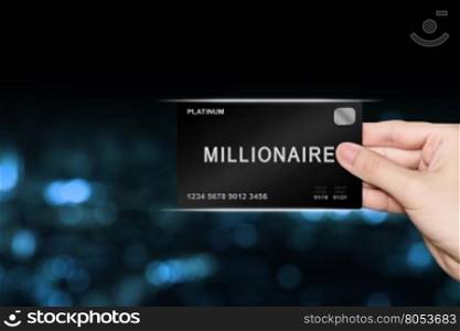hand picking millionaire platinum card on blur background