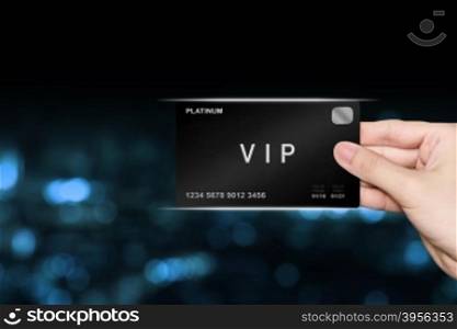 hand picking VIP or very important person platinum card on blur background