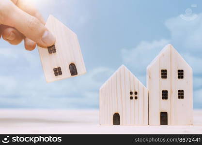 Hand placed or move home model for relocate or moving house concept.