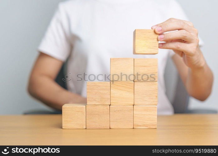 hand placing or pulling wooden block on the building. Business planning, Risk Management, Solution and strategy Concepts