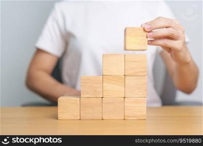 hand placing or pulling wooden block on the building. Business planning, Risk Management, Solution and strategy Concepts