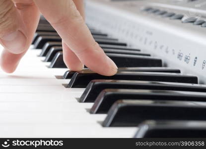 hand playing music on the piano