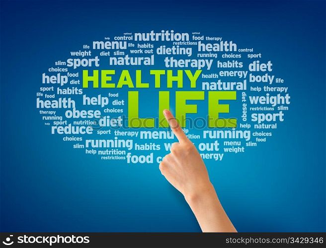 Hand pointing at a Healthy Life word cloud on blue background.