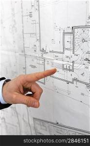 Hand pointing at an architect&acute;s diagram