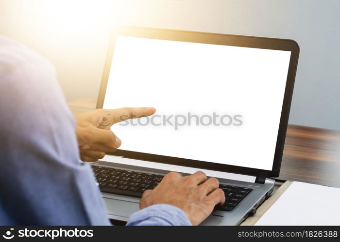 Hand pointing focus on computer in workspace office