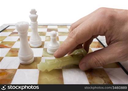 hand poses a chess piece on the board isolated on white background