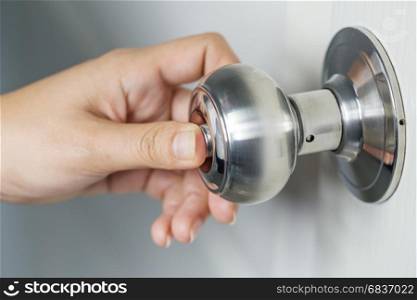 hand press botton on door knob for lock the white door
