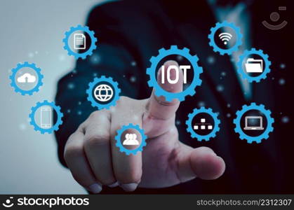 hand press on IOT or internet of things digital technology marketing, global business transformation concept.