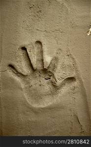 hand print on cement mortar wall with shadow relief