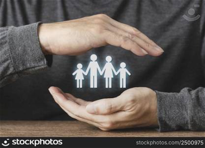 Hand protecting paper cut family figure , Health care and insurance for Protecting Family , concept for security and Medical care