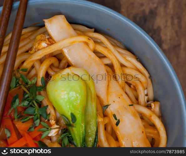 hand pulled stretched Chinese ramen noodles on a bowl with chopstick