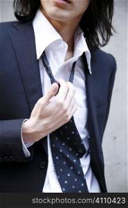 Hand pulling the necktie