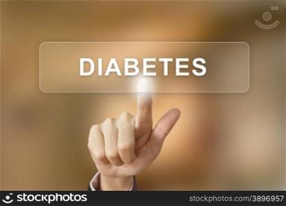 hand pushing diabetes button on blurred background