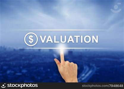 hand pushing financial valuation button on a virtual screen interface