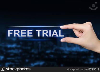 hand pushing free trial button on blurred blue background