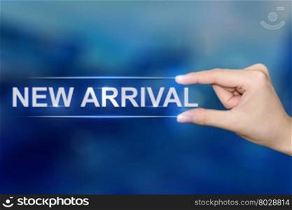 hand pushing new arrival button on blurred blue background