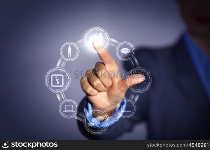 hand pushing on a touch screen. Business person pushing symbols on a touch screen interface