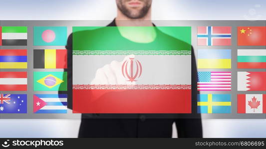 Hand pushing on a touch screen interface, choosing language or country, Iran