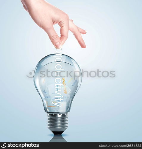 Hand putting a busines term into a light bulb