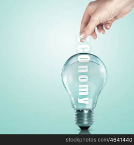 Hand putting a busines term into a light bulb