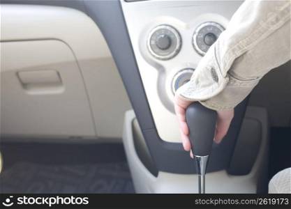 hand putting car in gear