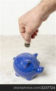 hand putting coin piggy bank