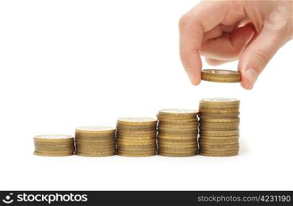 Hand putting coin to money staircase isolated on white background