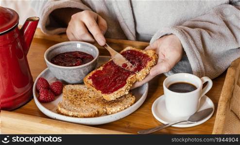 hand putting jam bread. High resolution photo. hand putting jam bread