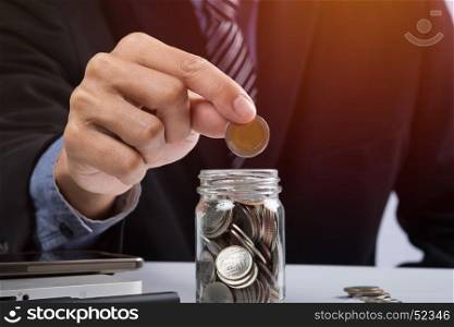 Hand putting mix coins and seed in clear bottle and copyspace, Business investment growth concept.