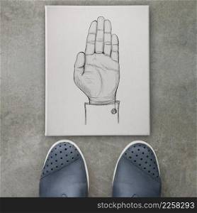   Hand raised draw sign on canvas board  on front of business man feet as concept