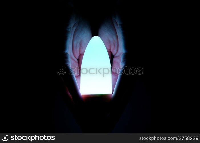 hand security luminous bulb on black background
