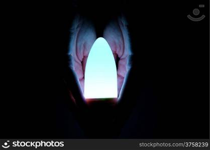 hand security luminous bulb on black background