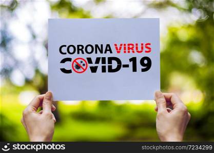 Hand show holding paper with word caution coronavirus covid 19