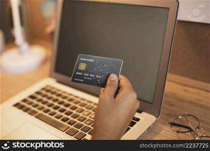 hand showing credit card laptop mock up