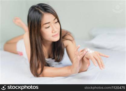 Hand Skin Care. Beautiful Asian Woman Applying Cream On Hands Skin