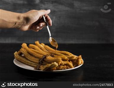 hand spoon with delicious fried churros