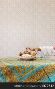 hand taking piece arab pastry. High resolution photo. hand taking piece arab pastry. High quality photo