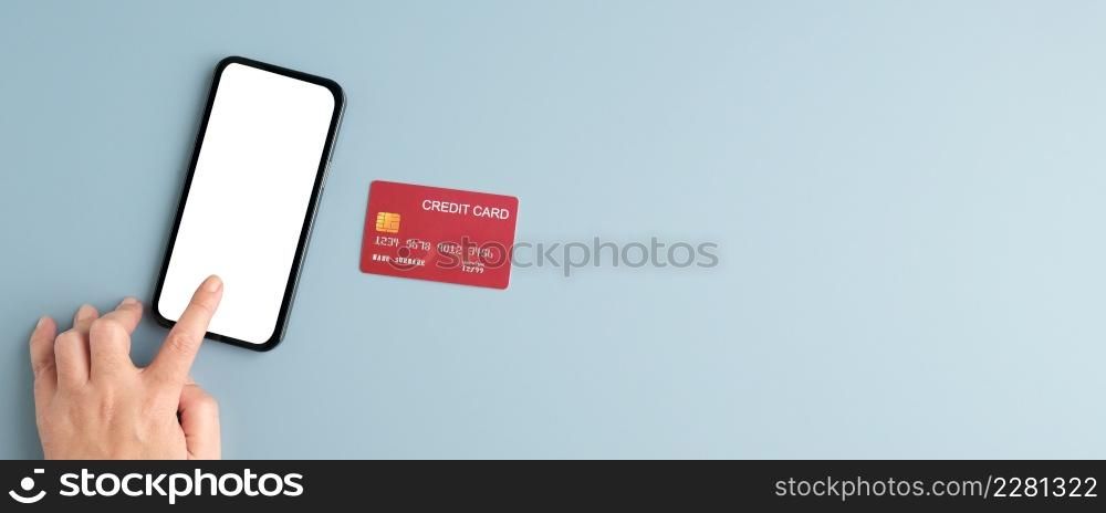 Hand touch blank screen mobile phone and credit card isolated on gray background, banner mock up, template, top view, flate lay, Business and technology