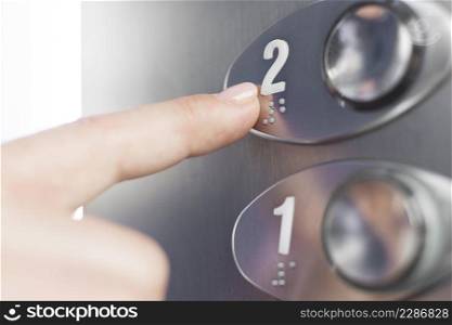 hand touching elevator braille figure 1