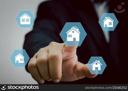 hand touching icon house.Real estate concept business, home insurance and real estate protection. Buy and sell houses and real estate online on a virtual.