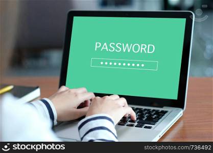 Hand tying laptop computer with password login on screen, cyber security concept