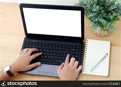Hand typing laptop with blank screen and blank paper notebook background, top view, flat lay, for mock up, technology, lifestyle