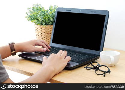 Hand typing laptop with blank screen for mock up, technology, lifestyle