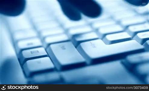 Hand typing on keyboard, macro view