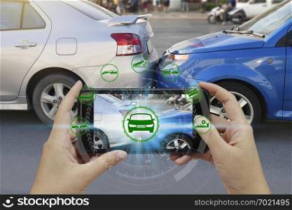 Hand use smartphone with car claim icons over the Network connection on car crash background, car accident for car insuranc claim concept.