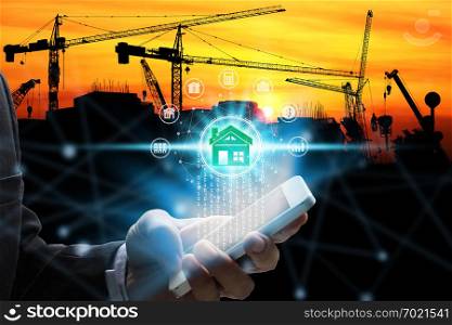 Hand use smartphone with property investment icons over the Network connection on property background, Property investment concept.