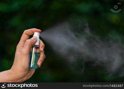 hand using alcohol spray for protect from infection of virus and germ Covid-19 coronavirus
