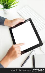 hand using digital tablet on desk vertical view