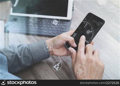 Hand using mobile payments online shopping,omni channel,icon customer network,in modern office wooden desk, graphic interface screen,eyeglass,filter